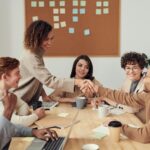 Diverse team collaborating in a meeting, showcasing teamwork and cooperation in a modern workplace.